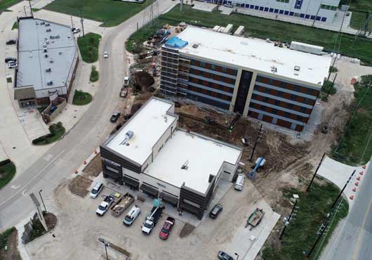 Aerial view of Home2 Suites and Riverpointe Retail Center building under construction for Noble Merchant Properties, located on U.S. 59 and Grand Parkway in Richmond, Texas. 